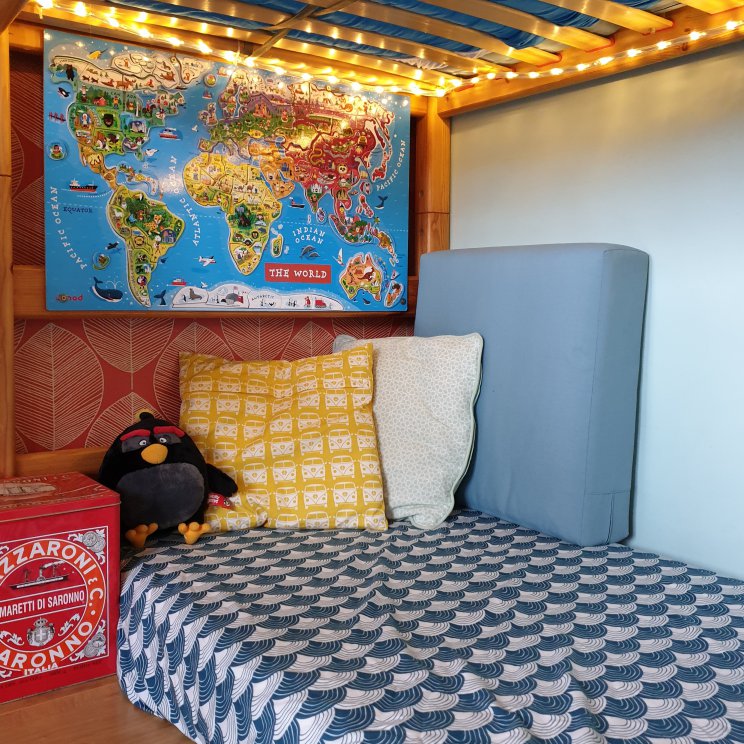 Kinderkamer inspiratie: retro jongenskamer met hout, blauw, rood en geel - hoeslaken van swedish linens en magnetische wandkaart van janod