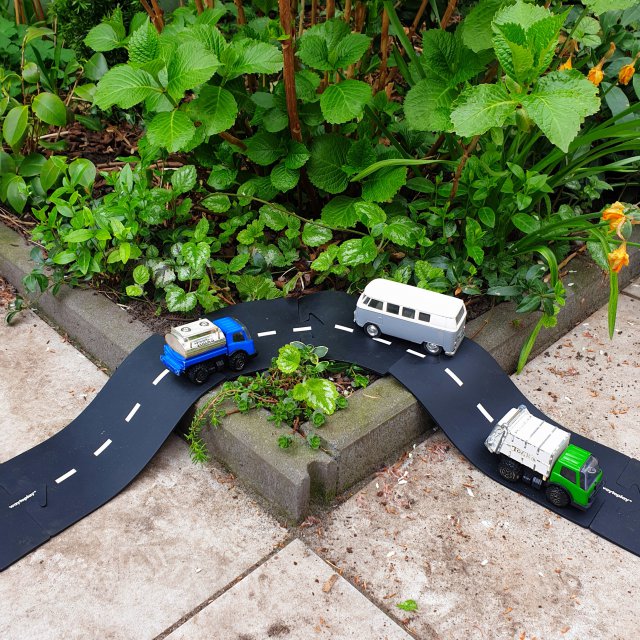 Way to Play flexibele autobaan: leuk binnenspeelgoed en buitenspeelgoed. In de tuin is het leuk om waytoplay over een verhoging heen te bouwen. Zoals hier over de hoek van de border. 