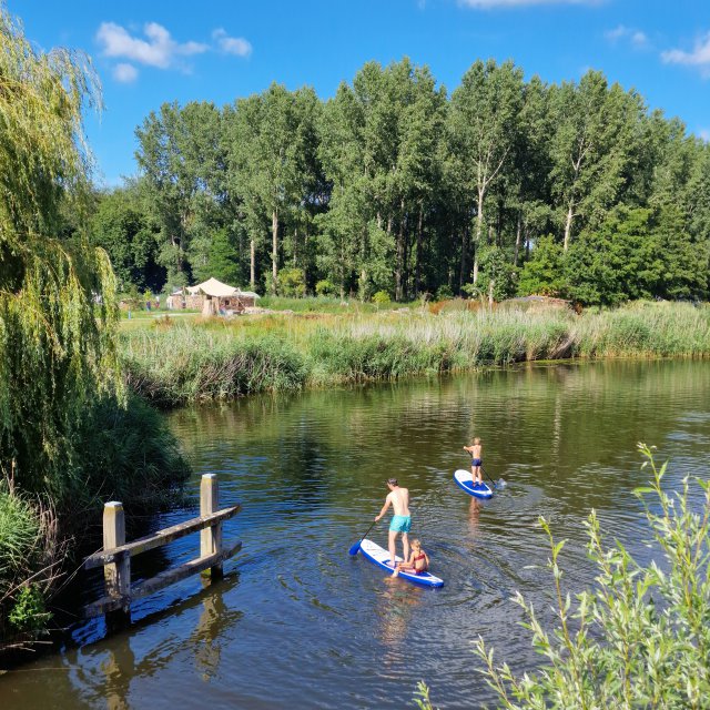 Terra Wolde met kinderen: eco buiten hotel en luxe camping. Je kunt hier zwemmen, aan het water liggen sups, even verderop is een steiger.